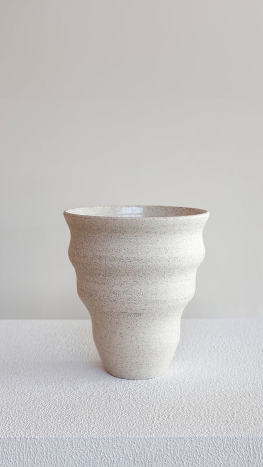 Picture of a white and black speckled vase 